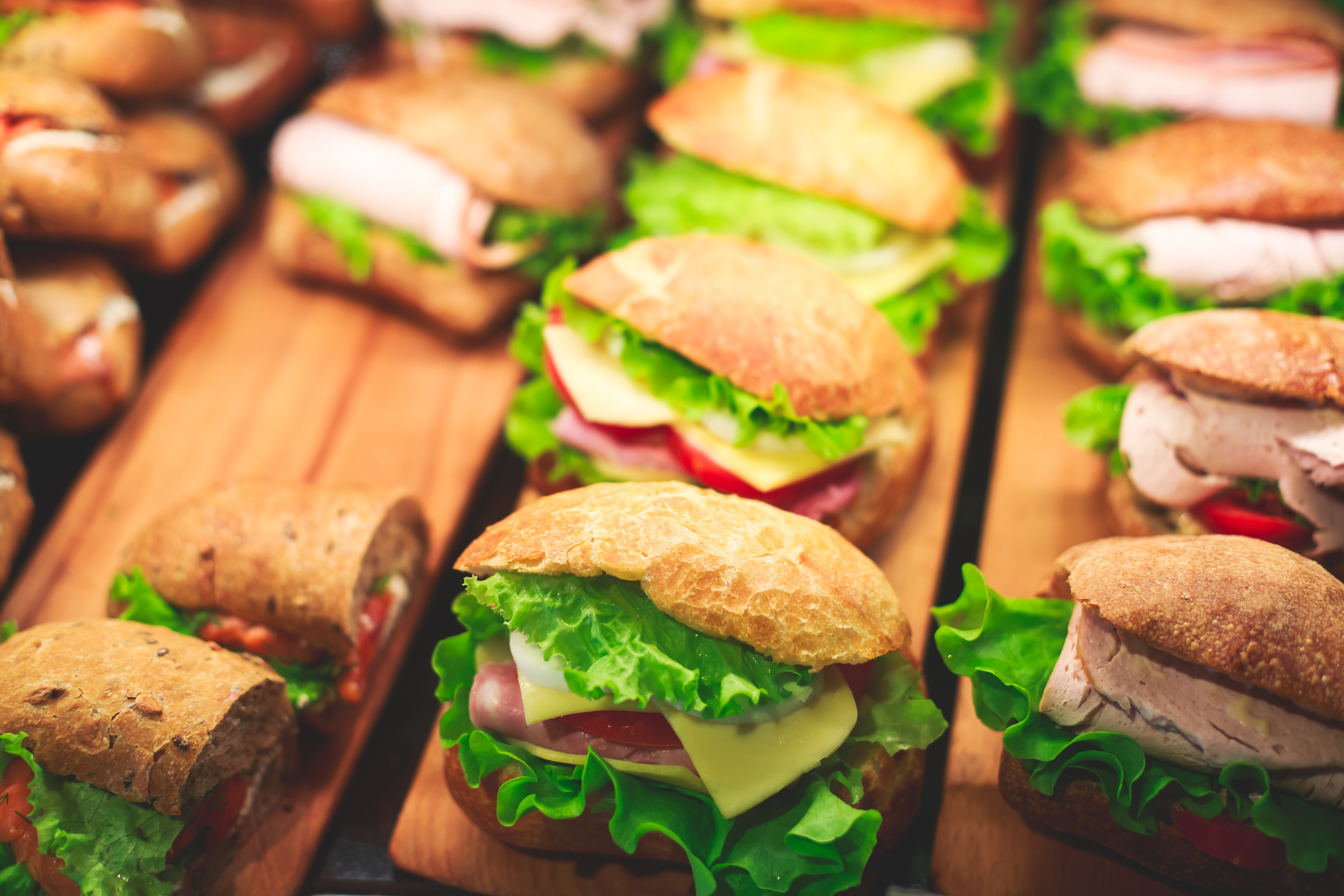 Beautifully decorated catering banquet table with different food snacks and appetizers with sandwich, on corporate christmas birthday kids party event or wedding celebration